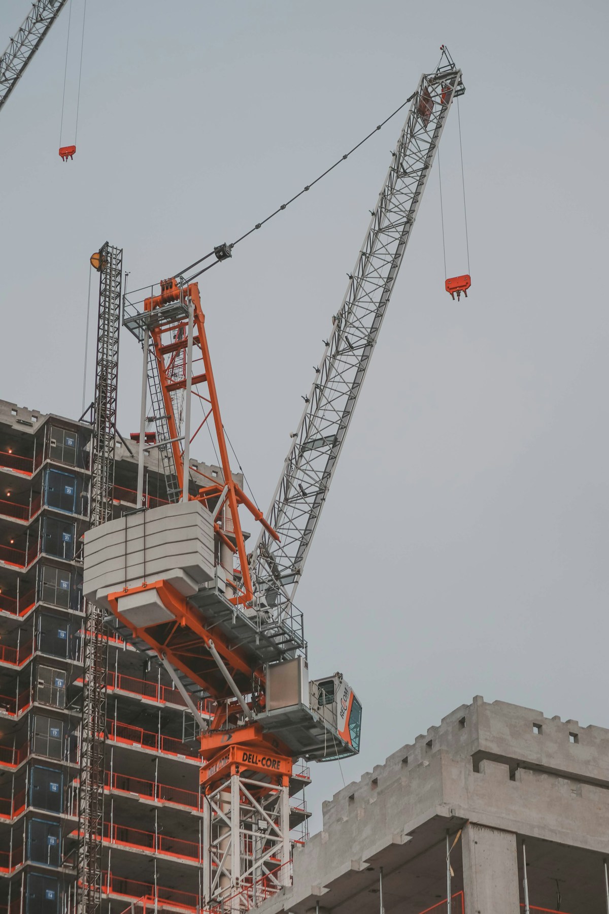 Construction site with a crane and the structure of a new residential building